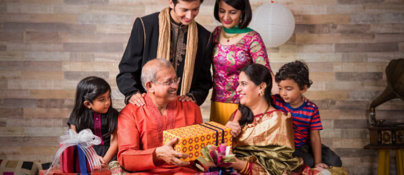 Grandfather receiving Diwali gift box from family members