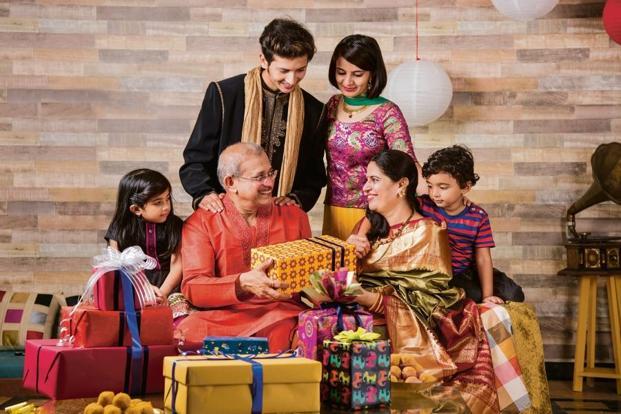 An Indian family exchanging Diwali gifts, bought by using innovative Diwali gift ideas