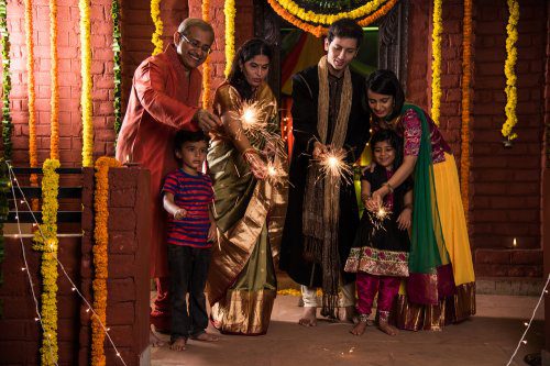 An Indian family celebrating Diwali with crackers