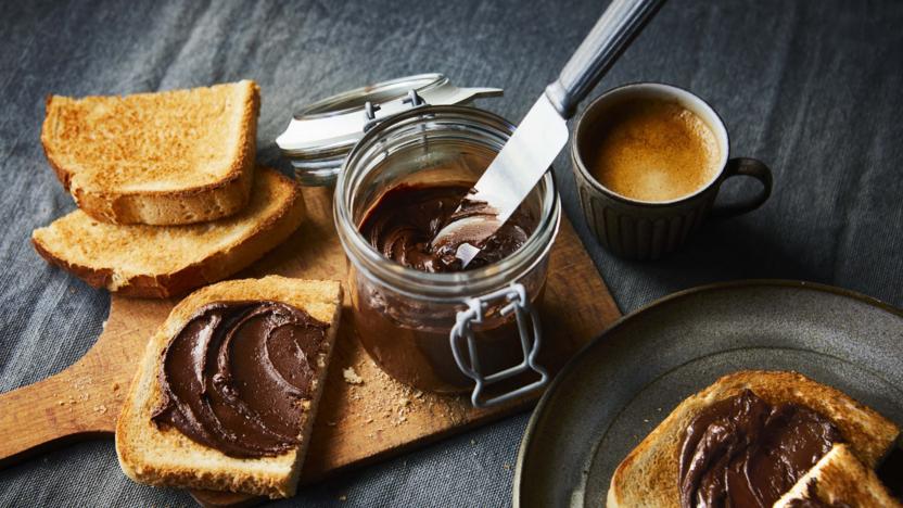 Spreading dark chocolate peanut butter on bread