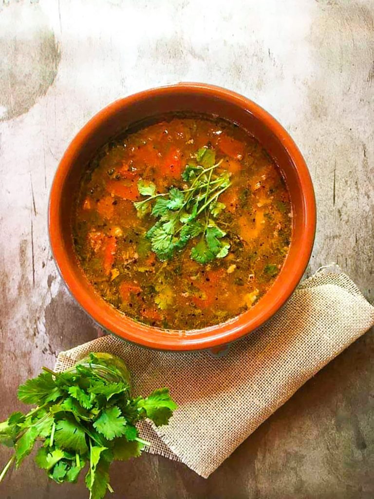 A bowl full of tomato rasam