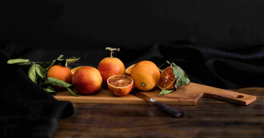 An tray full of various types of oranges