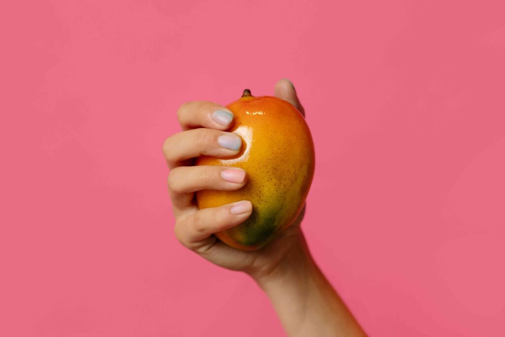 Someone holding a mango