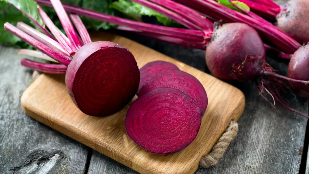 A halved beetroot on cutting board