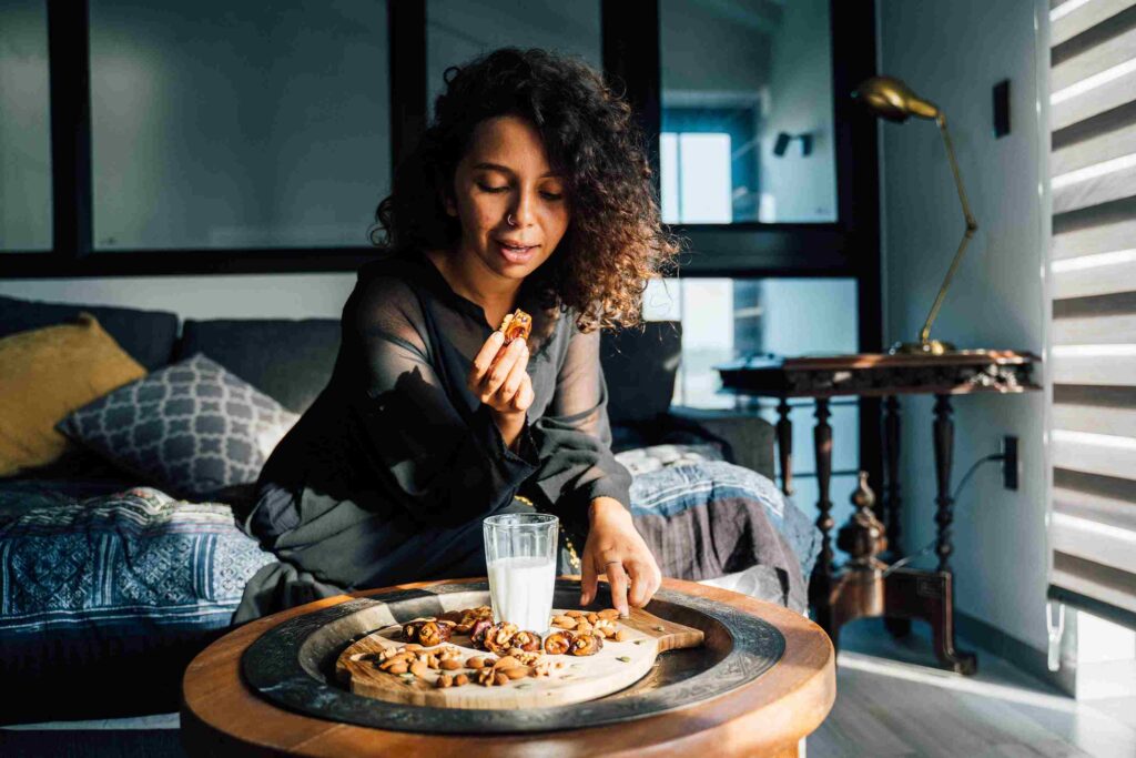 A woman eating dates